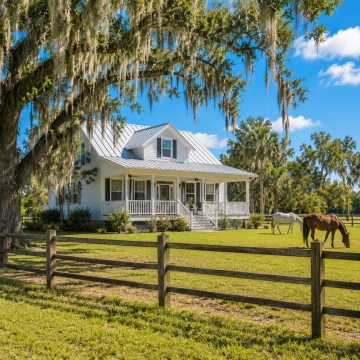 Country-style home with fenced acreage and horses representing Buckingham near Fort Myers